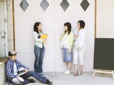 Fresh Japanese Young People Relaxing Near Retro White Wood Door