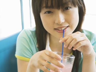 Fresh Japanese Teen Girl Drinking Pink Drink By Window