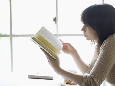 Japanese Girl Reading Book By Window With Afternoon Tea