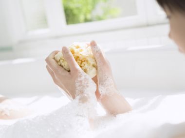 Relaxing Bath Scene With Natural Sponge In Bright Sunlit Bathroom