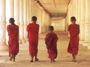 Young Buddhist Monks Walking In Cambodia Temple Corridor