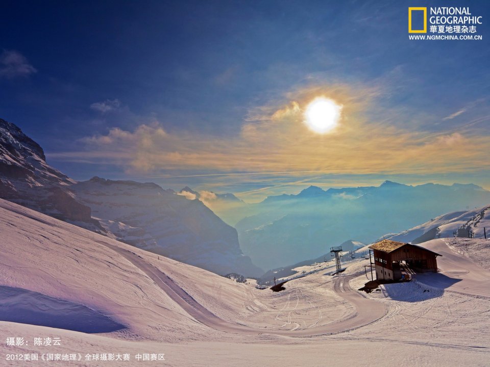 Snowy Mountain Cabin And Sunlit Mountain Landscape
