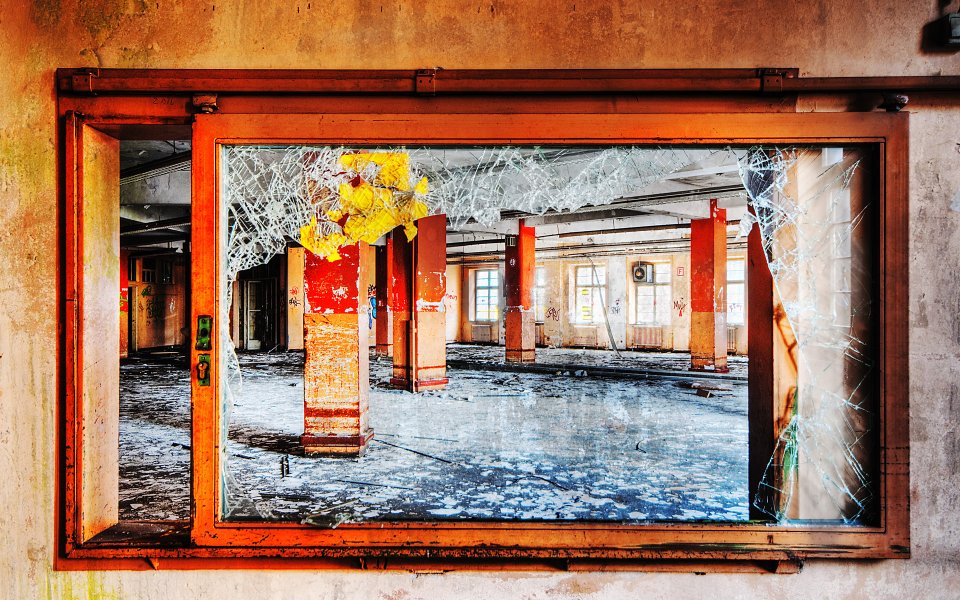 Abandoned Industrial Building Interior Broken Glass And Worn Columns