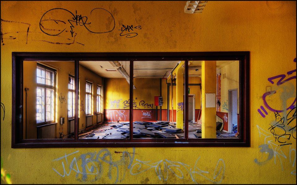 Abandoned Building Interior With Yellow Walls And Graffiti