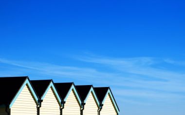 British Beach Huts And Clear Blue Sky
