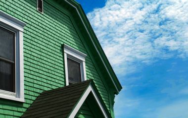 North American Style Green House And Blue Sky With White Clouds