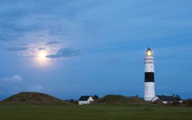German Coastal Black And White Striped Lighthouse And Serene Moonlit Grassland Landscape