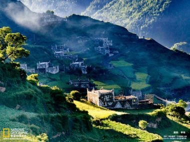 Traditional Village In Chinese Mountainous Area With Morning Mist And Terraced Fields