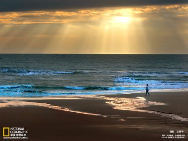Lonely Walker On Chinese Beach At Sunset