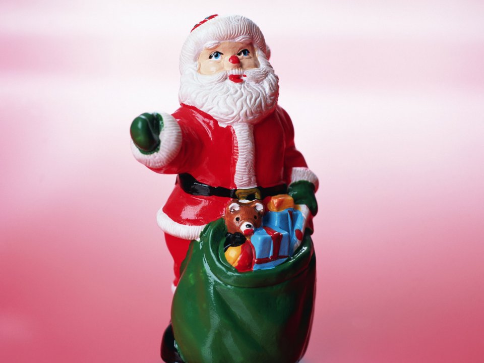 Santa Claus Figurine With Gift Bag Pink Background