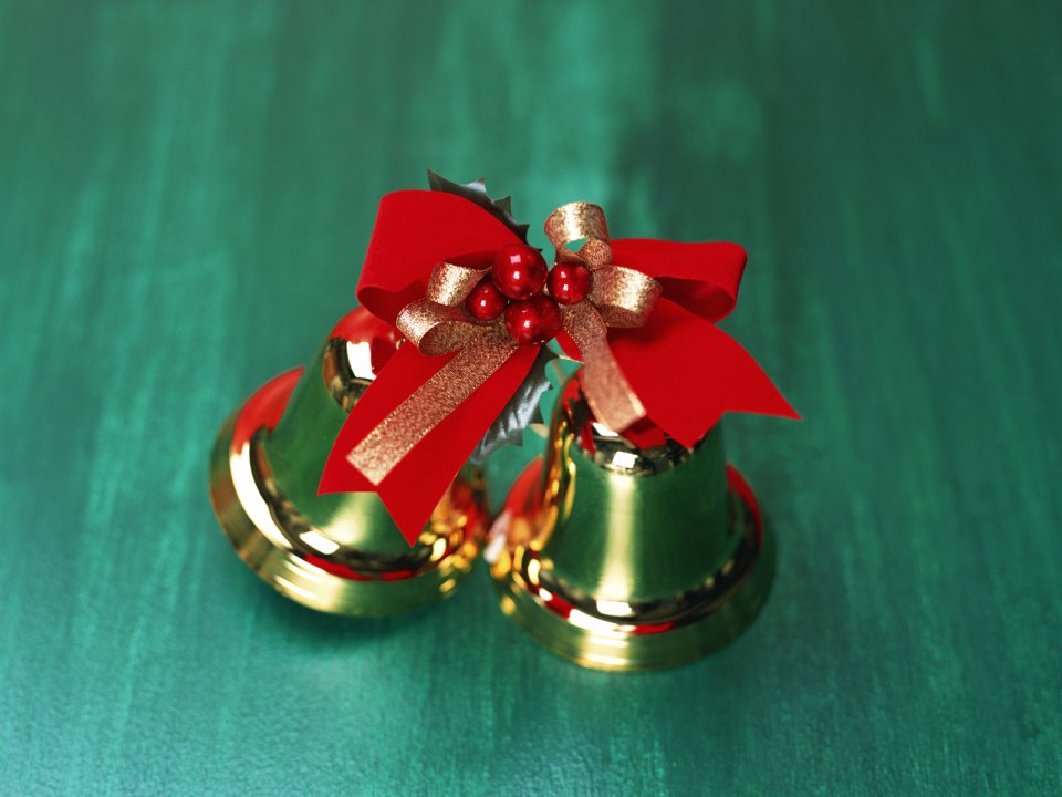 Golden Christmas Bells With Red Bow On Green Background