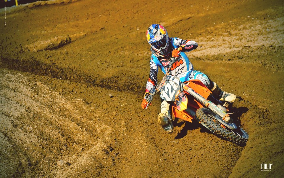 Motocross Rider On Dirt Track With Red Bull Sponsorship