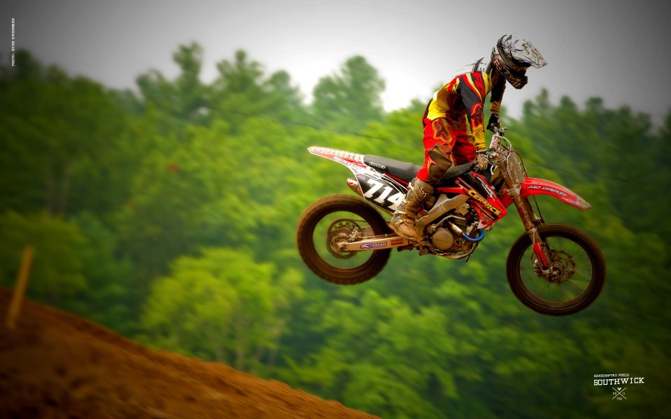 Motocross Rider Jumping In Forest Track