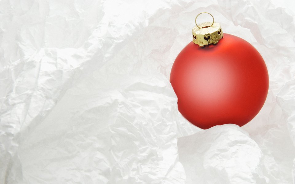Red Christmas Ornament On White Crinkled Paper