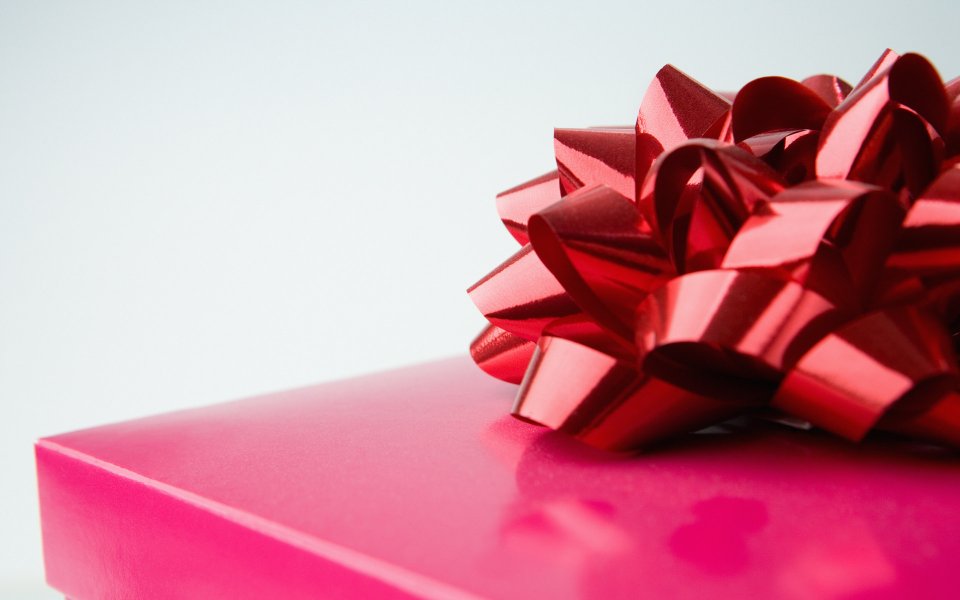 Close Up Red Ribbon On Pink Gift Box