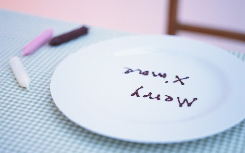 Chocolate Sauce Christmas Message On White Plate