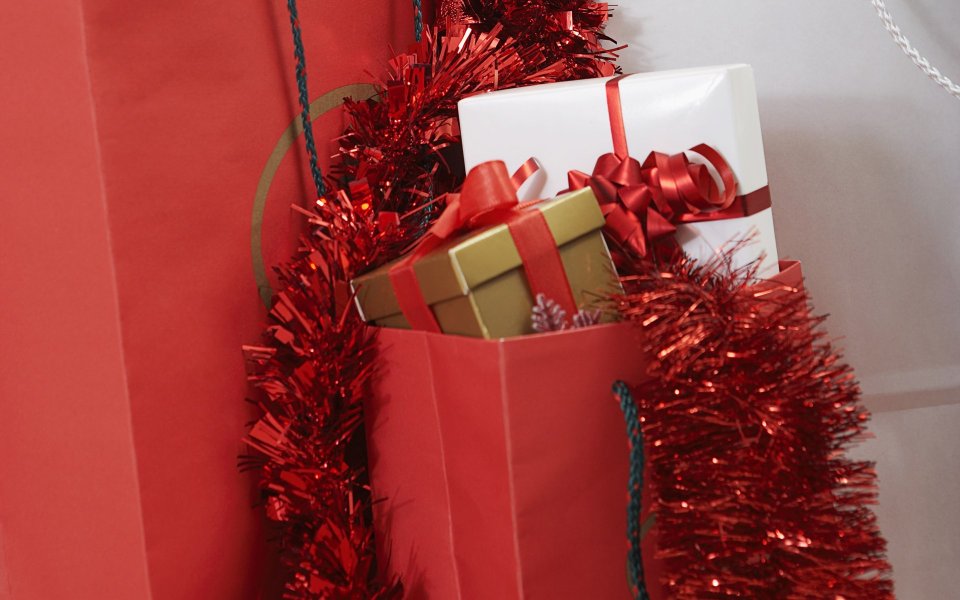 Close Up Of Christmas Gifts In Red Bag