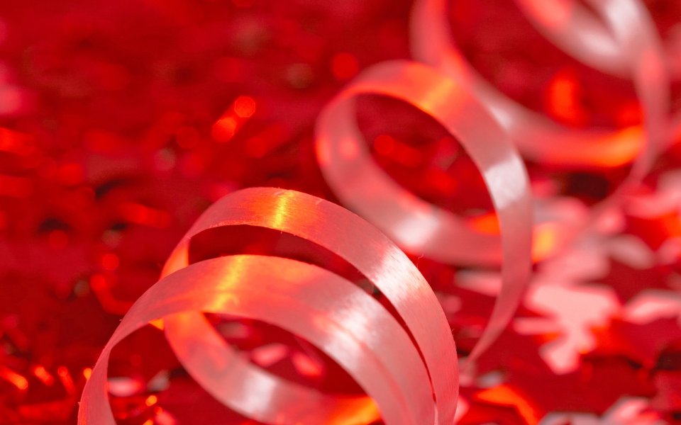 Close Up White Spiral Ribbon On Red Glitter Background