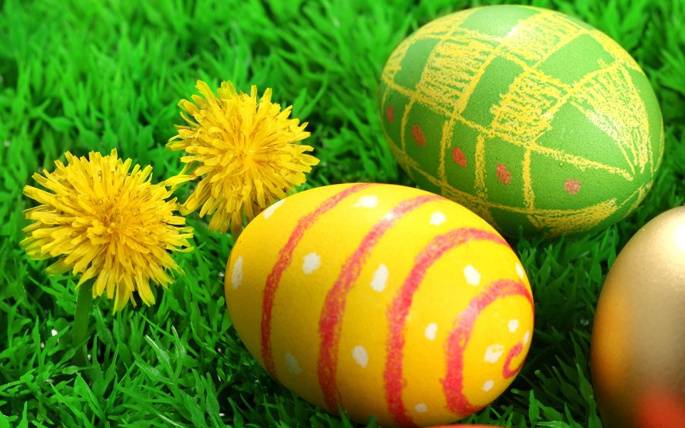 Painted Easter Eggs And Dandelions On Grass