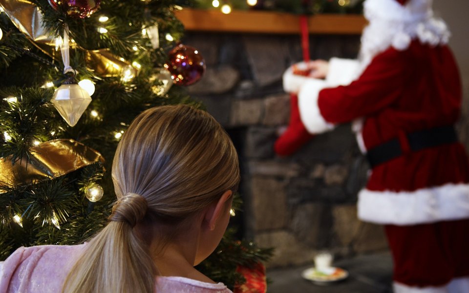 Little Girl Watching Santa Hanging Stocking