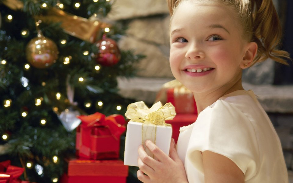 Smiling Girl Holding Christmas Gift