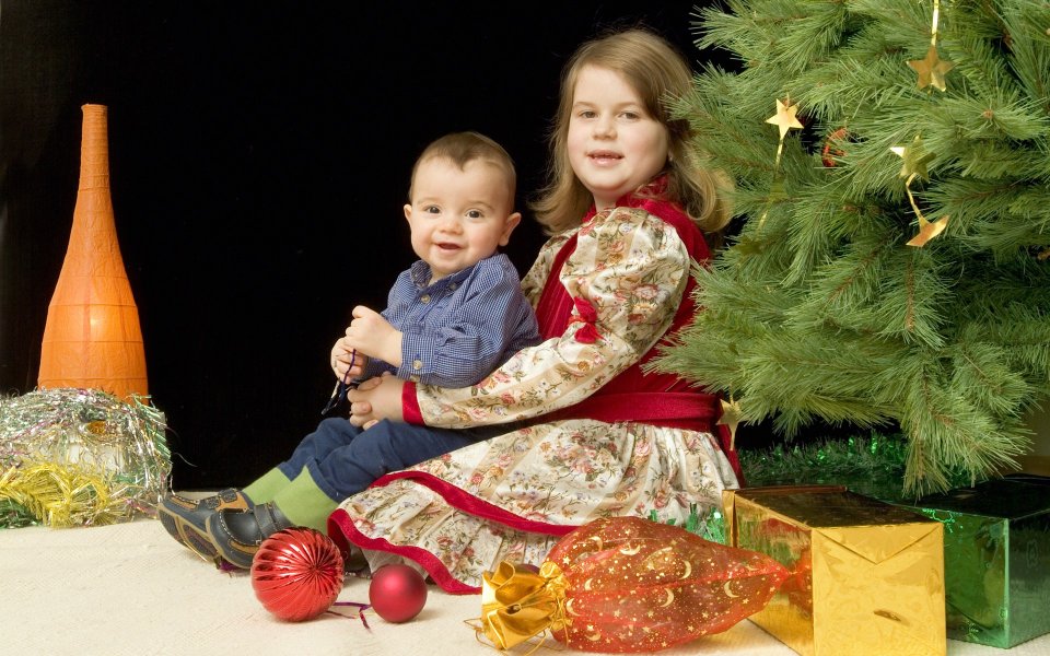 Siblings Under Christmas Tree