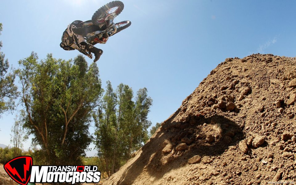Motocross Rider Mid Air Jump Over Dirt Mound Scene