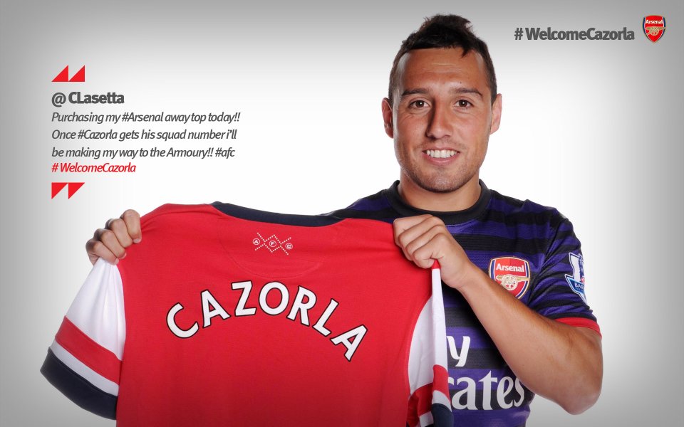 Arsenal Player Cazorla Shows Team Jersey