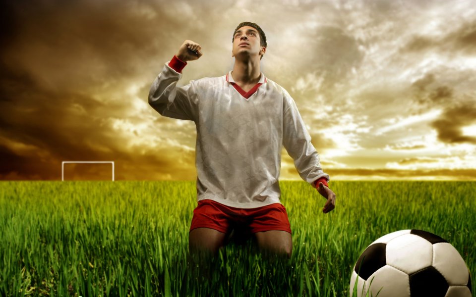 Celebrating Soccer Player At Dusk Green Field Wallpaper
