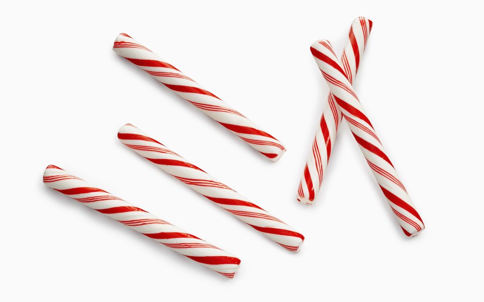 Red And White Striped Christmas Candy Canes On White Background