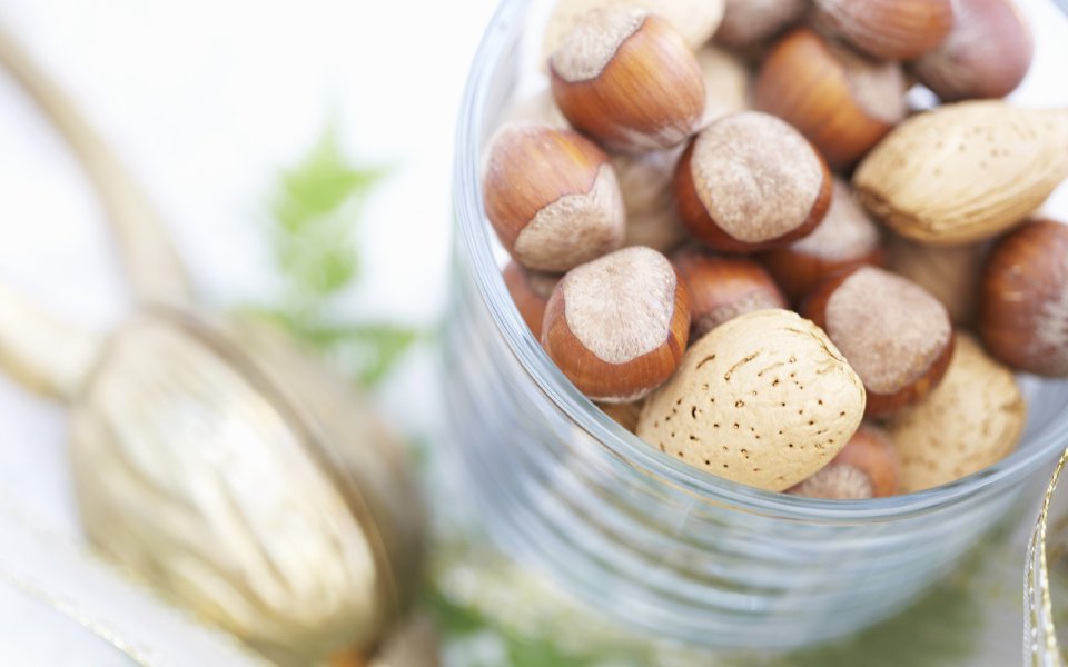 Close Up Of Hazelnuts And Almonds In A Glass Jar