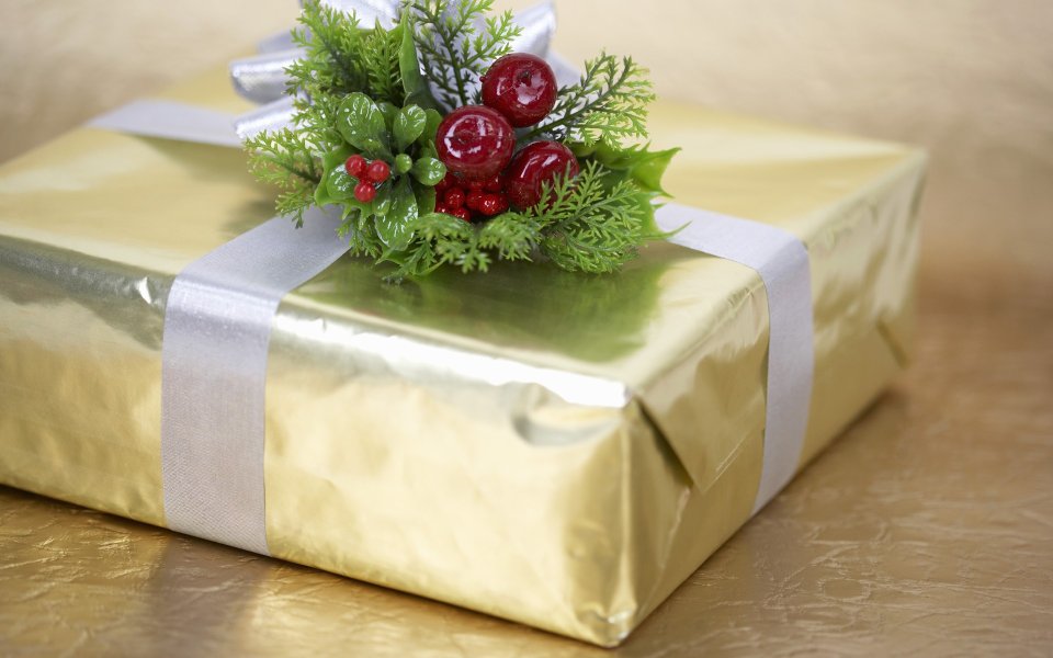 Gold Wrapped Christmas Gift With Holly