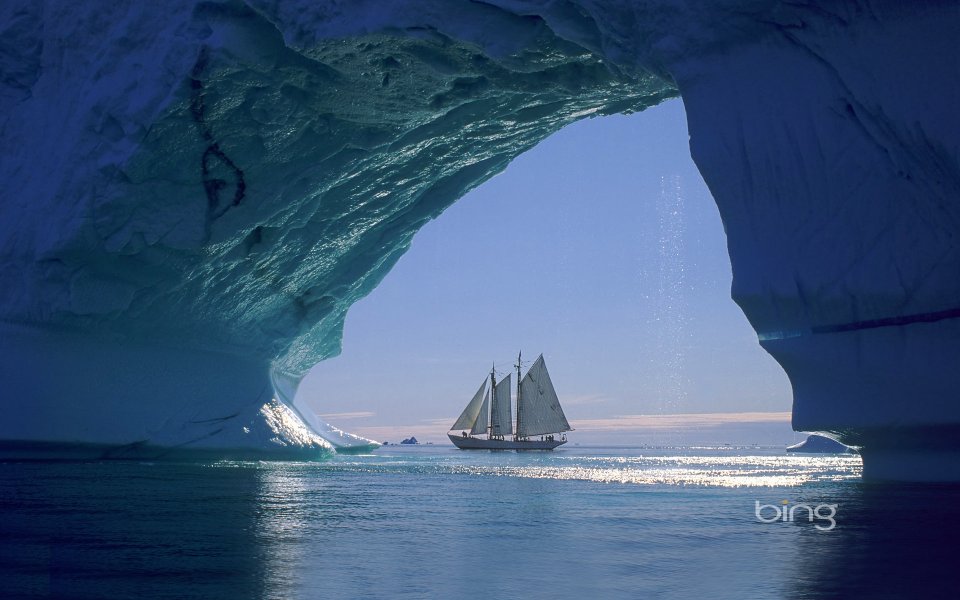 Iceberg Arch And Sailboat Off Greenland Coast