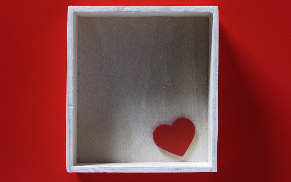 Red Heart In White Wooden Frame On Red Background