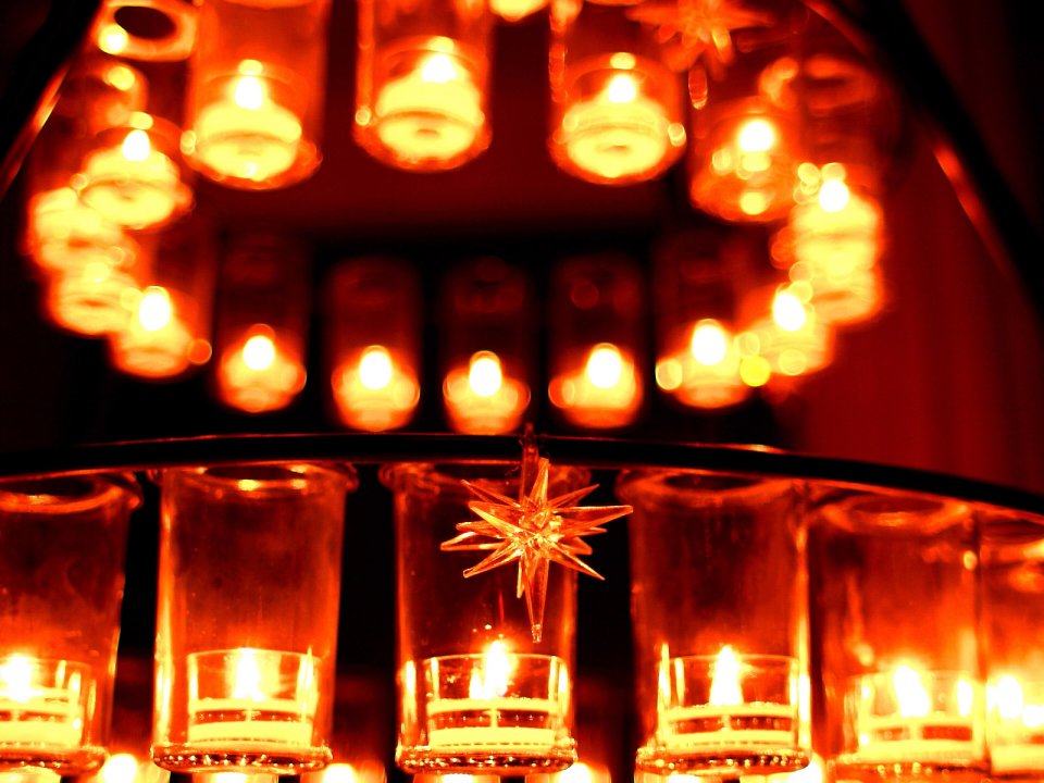 Warm Toned Candlelight And Star Ornament Closeup