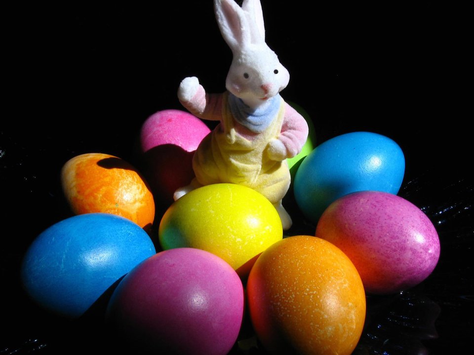 Colorful Easter Eggs And White Bunny Toy On Black Background
