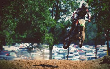 Motocross Rider Jumping On Dirt Track