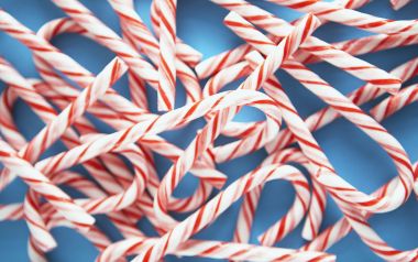 Close Up Red And White Candy Canes Blue Background