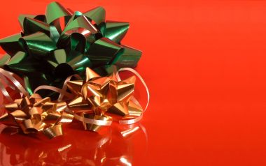 Green And Gold Christmas Bow On Red Background