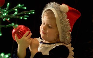 Little Girl Holding Red Christmas Ornament