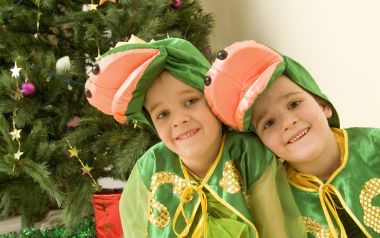 Twins In Green Costumes By Christmas Tree