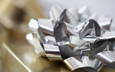 金色礼盒上的银色金属质感蝴蝶结特写