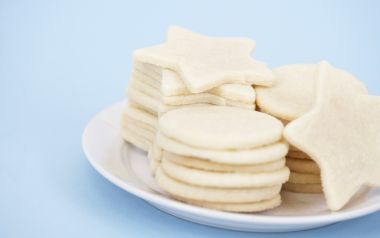 蓝色背景下白色糖霜星星与圆形饼干堆叠特写