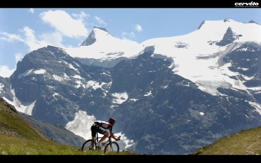 Mountain Cyclist With Snowy Mountain Background