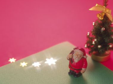 Close Up Santa Claus And Christmas Tree Pink Background