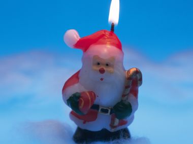 Santa Claus Candle Burning Blue Background