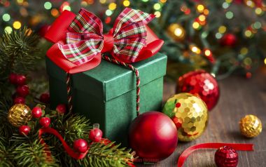 Green Christmas Gift Box With Red Bow And Pine Branches