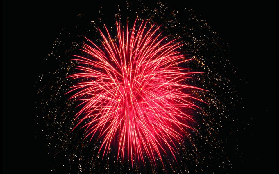 Bright Red Fireworks Bursting On Festival Night Sky
