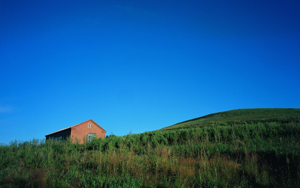 Vast Summer Grassland Red Brick Cabin Clear Blue Sky