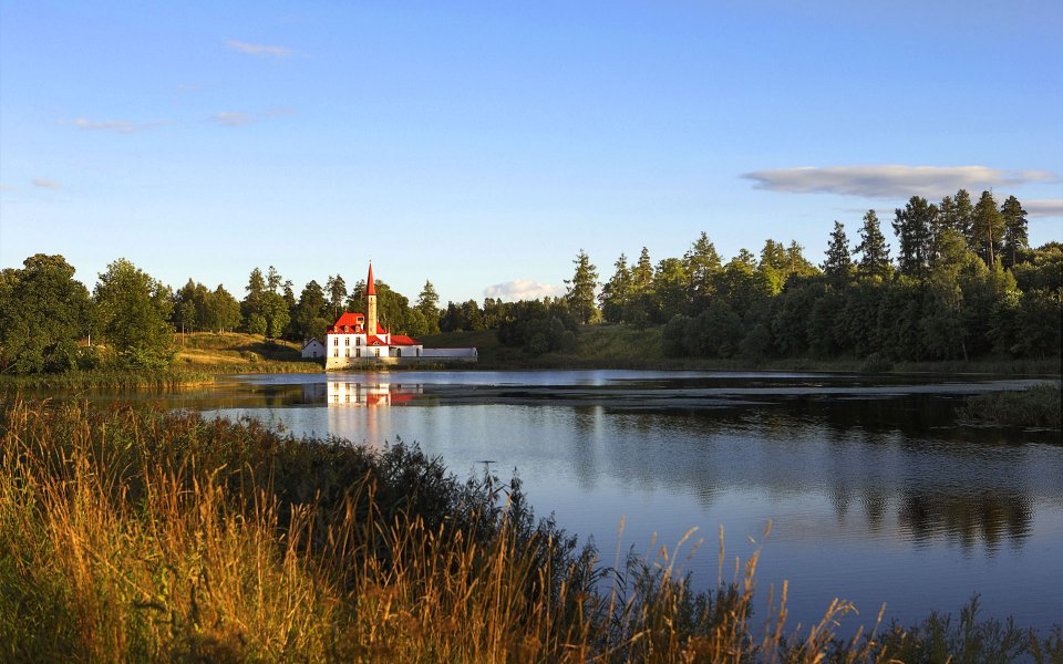 Red Roof Spire Building By Lake European Countryside Scenery